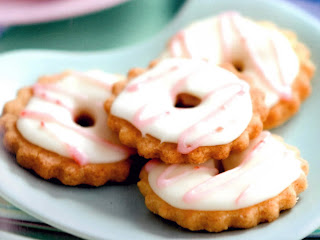 Celebration biscuits: Spiced white biscuits with a hole topped with white icing and pink icing. Baked especially for Easter