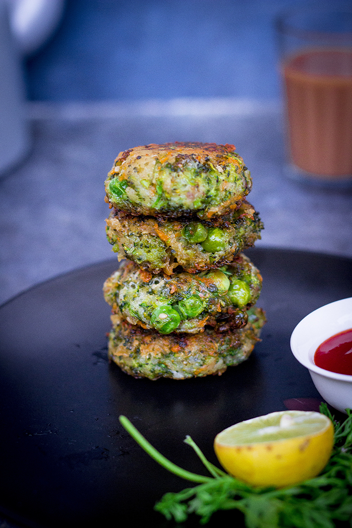 Shallow fried fritters made from broccoli and zucchini stacked together