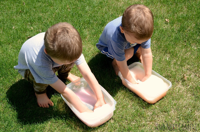 Children playing with colored soap foam sensory bins