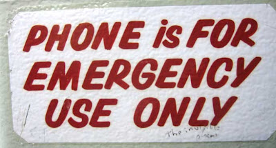 Red-lettered sign reading Phone for emergency use only with graffiti saying The invisible phone