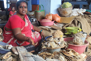 A woman selling dry fishes