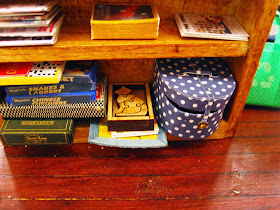 Modern dolls' house miniature games shelf.