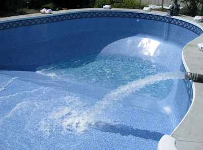 image of a pool getting filled with water. A guide to preparing your pool for the summer