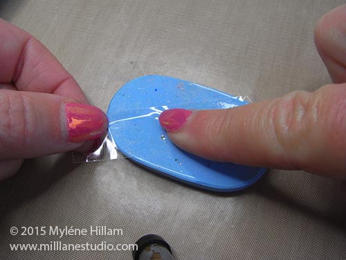 Pressing sticky tape onto the silicone.