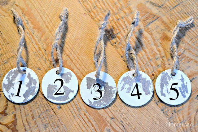 distressed metal hang tags in a row