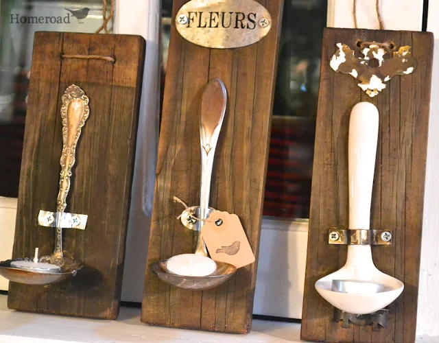 three ladles mounted on reclaimed wood with tea light candles