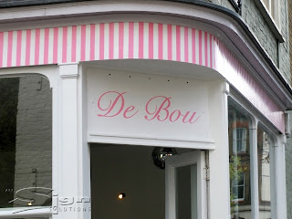 Pink painted letters using paint mask on the shop front