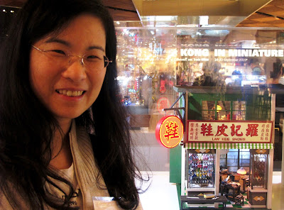 The maker standing next to the miniature model of a Hong Kong shoe shop from the 1960s at the Hong Kong in Miniature exhibition.