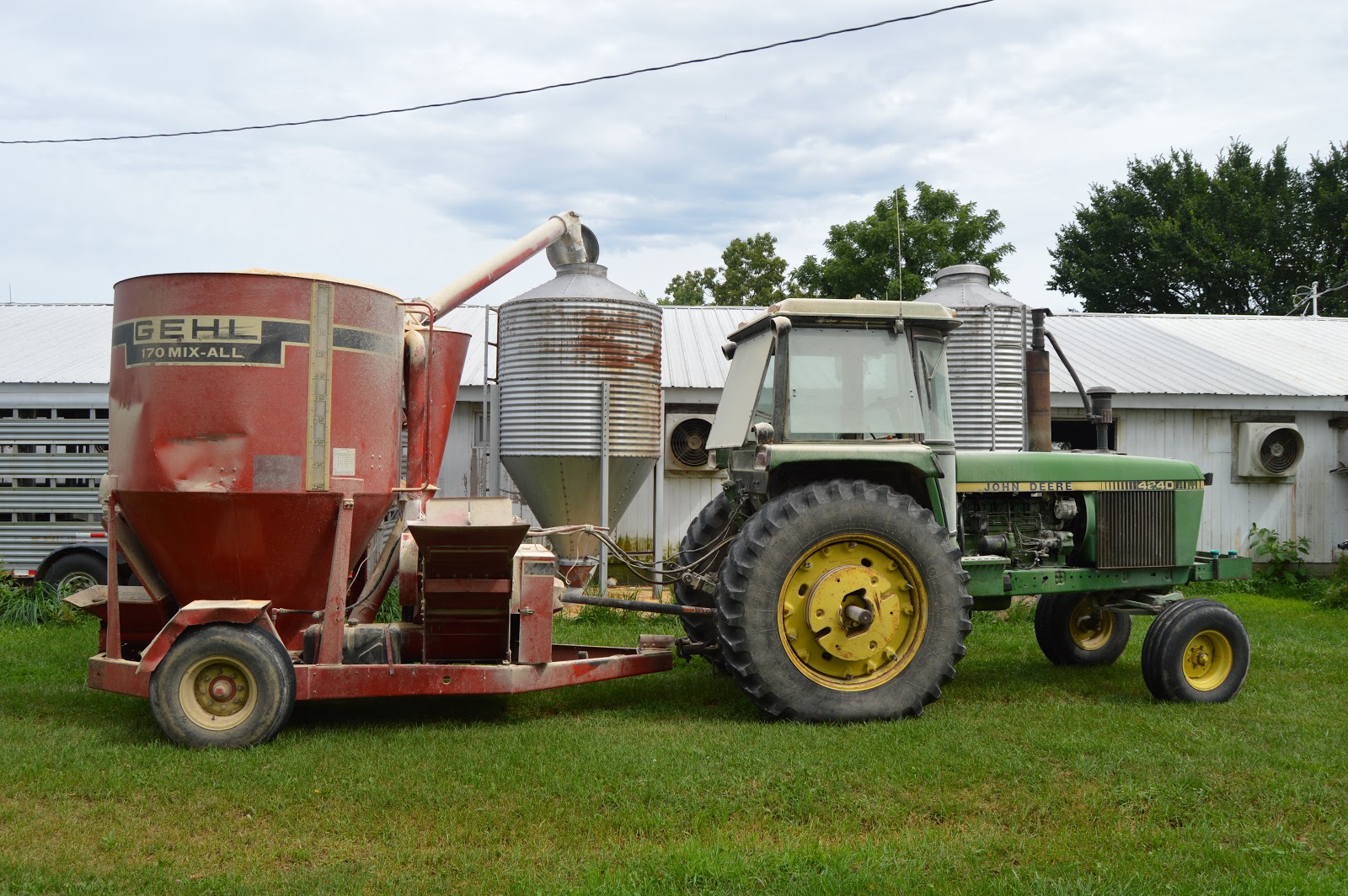 Industrial History Tractor implement to grind, mix, and deliver feed