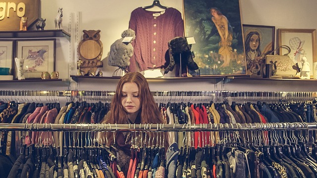 Woman in shop browsing clothes. This is also a link to blog