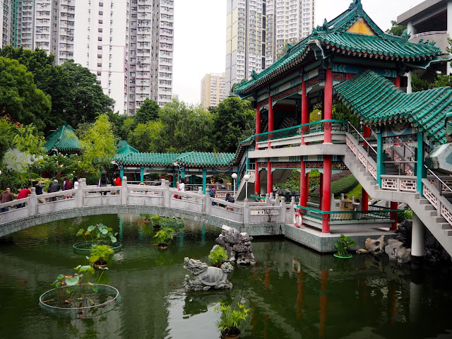 Traditional Chinese architecture of pavilion & bridge on the pond in the garden of Sik Sik Yuen Wong Tai Sin Temple, Hong Kong