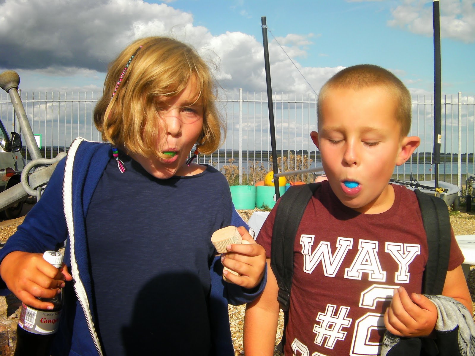 boy and girl eating blue and green gob-stoppers gobstoppers like pool balls blue green at portsmouth watersports centre