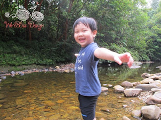 Henry happy playing in the river