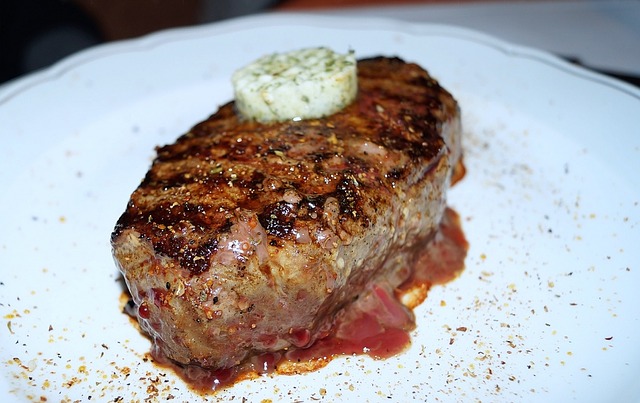 Pat of Butter Sitting on Top of a Flat Iron Steak