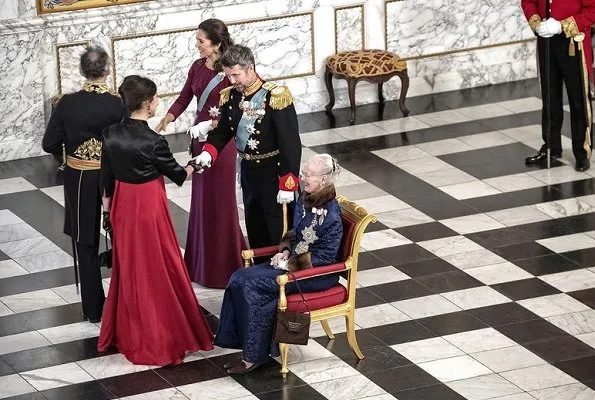 Crown Princess Mary in a fuchsia dress and cape by Danish designer Lasse Spangenberg
