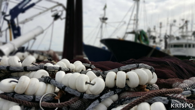 detalle de boyas de redes de pesca junto a barcos pesqueros