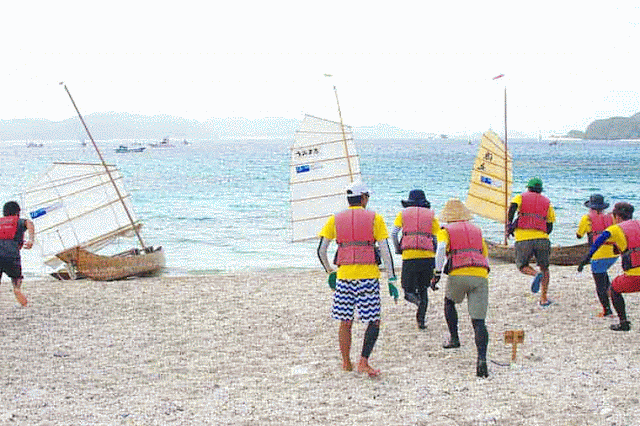 teams run towards beached boats