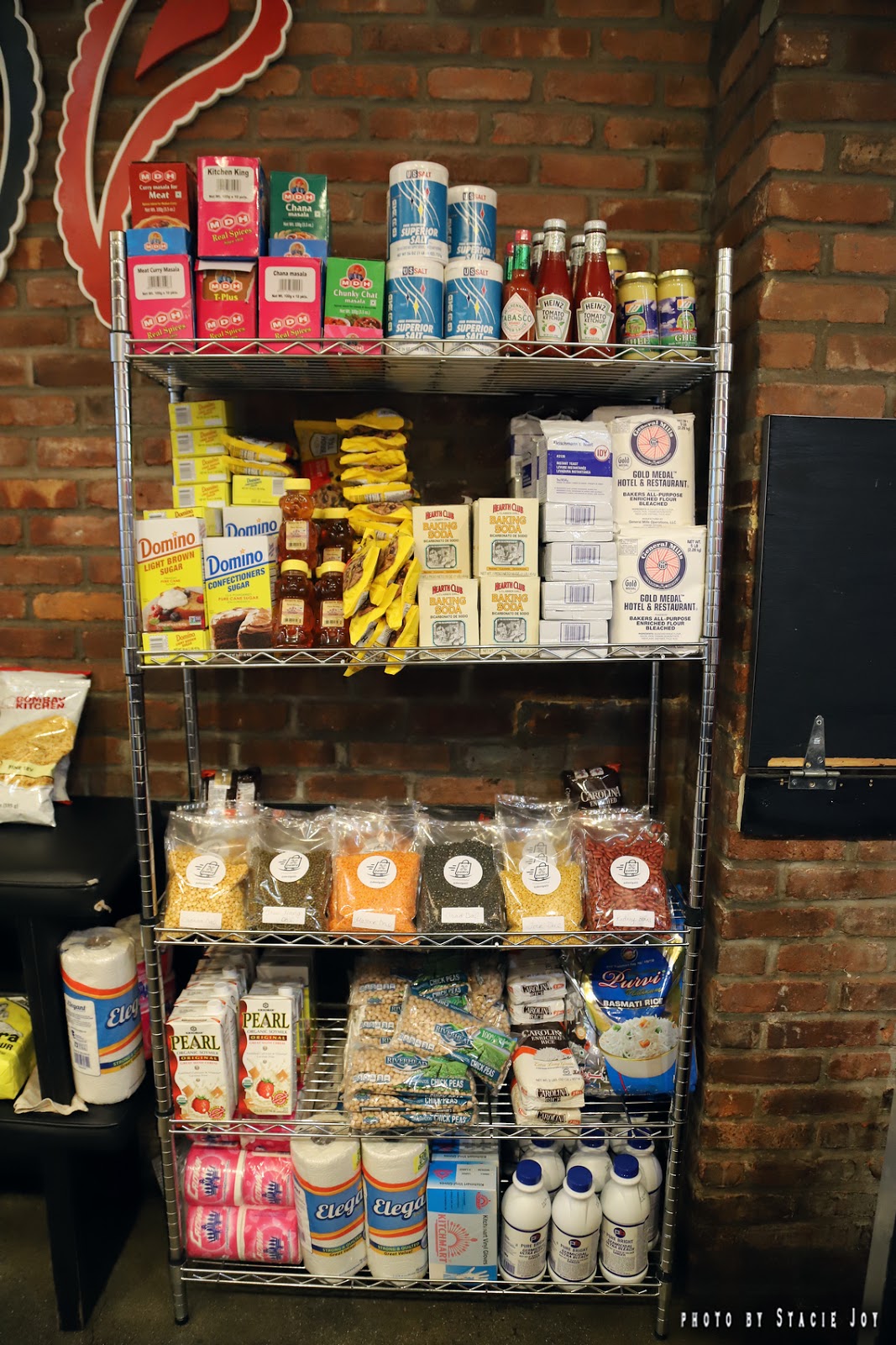 EV Grieve Desi Galli opens a pantry section, with meal kits, supplies