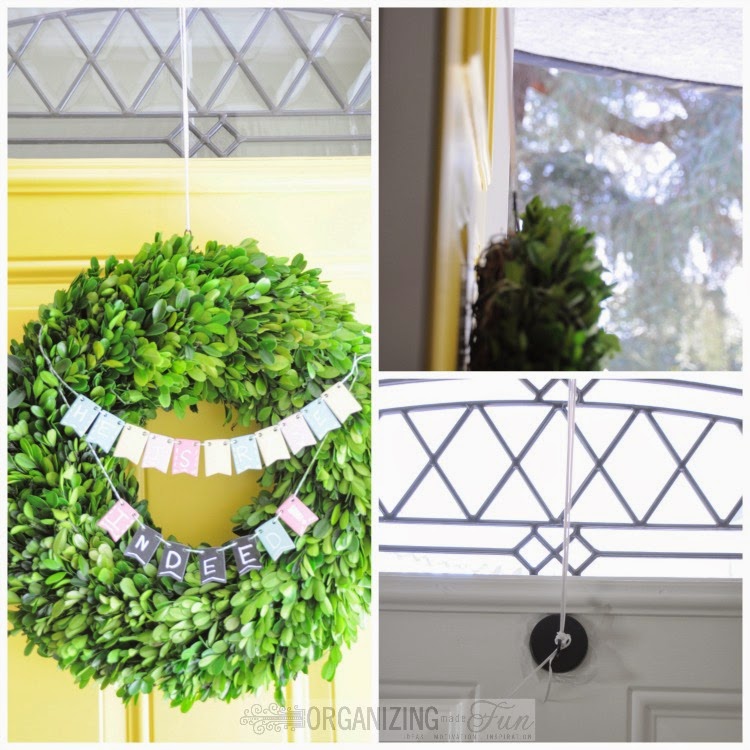 Rigging up a way to hang the heavy boxwood wreath, using plastic lace over the door and a magnet on the back of the door :: OrganizingMadeFun.com