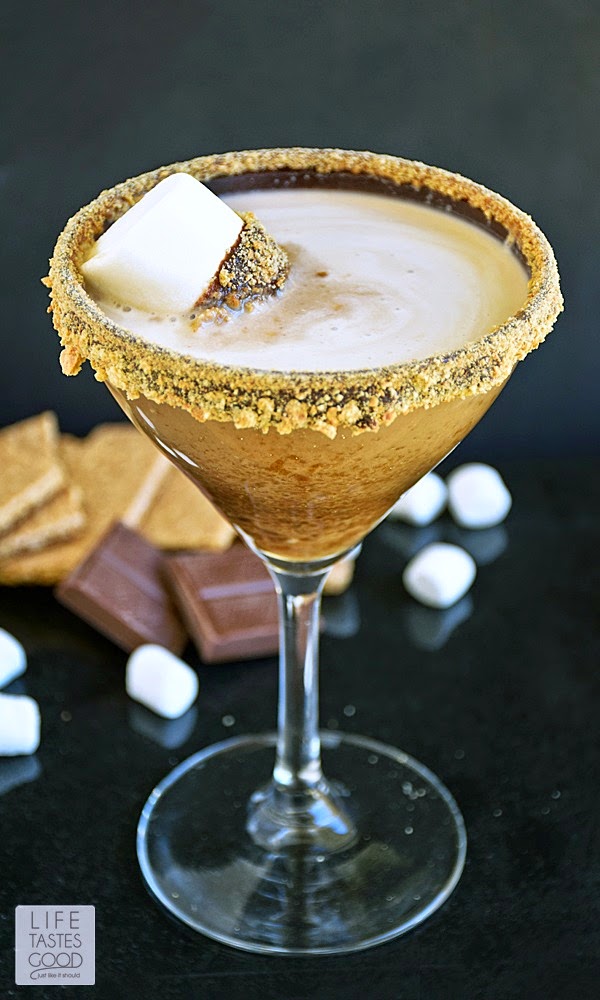 S'moretini | by Life Tastes Good is chocolate liquor, marshmallow infused vodka, and cream served in a martini glass rimmed with chocolate ganache and graham crackers! All of these wonderful flavors combine to make a drink that tastes like our favorite camping treat - s'mores! It makes a super fun party cocktail too!