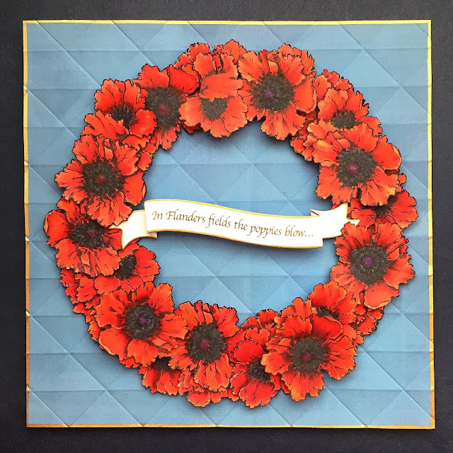 Red poppies wreath on blue background, against a Navy ground. Gold borders on card and banner.