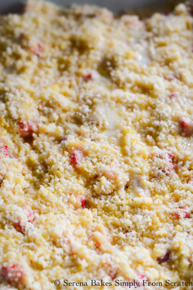 Spread Strawberry Rhubarb Cobbler topping over the top of berries and drizzle with butter.