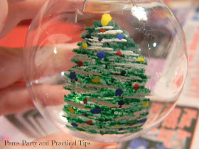 Adding the lights to the painted Christmas tree ornament 