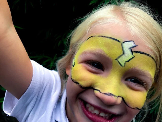 Snazaroo mini theme pack used to create a yellow super hero mask with white lightning bolts and black outline