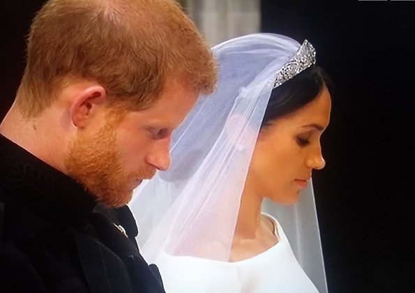 The veil is held in place by Queen Mary's diamond bandeau tiara, lent to Ms. Markle by The Queen. 