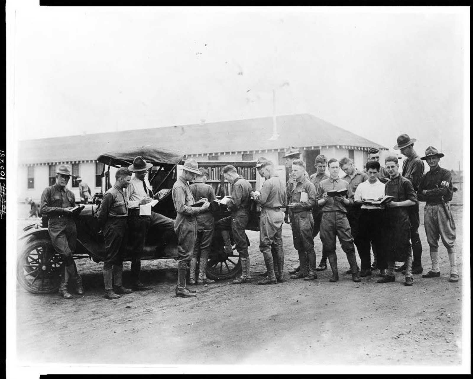 Soldiers getting library books from a truck, Kelly Field Library, Texas, c. 1917.