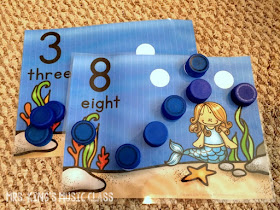 Princesses Don’t Do Math – Number Mat Ideas for a Reluctant Learner.  You’ll love these number mat ideas for getting your reluctant preschooler playing, counting and adding their way to success.  Number mats are great for developing number sense and these mats work with bottle caps!  They can work with playdough, rocks, and more but I think you’ll like how perfectly the bottle caps can work with any theme.  Great for preschool and kindergarten aged students in workstations or at home.
