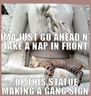 cat sleeping on statue making gang signs