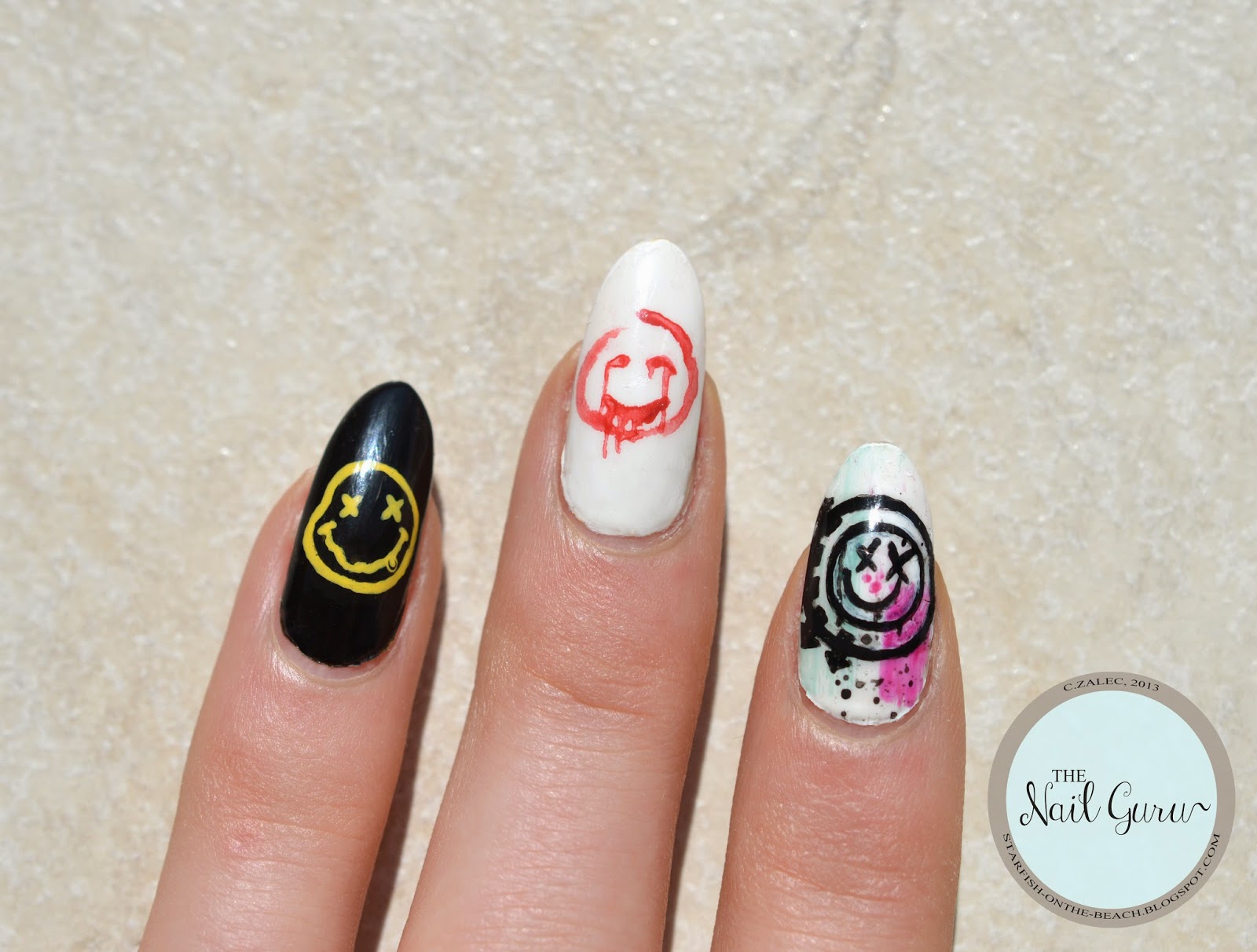 Black Nails With Smiley Face On Ring Finger.