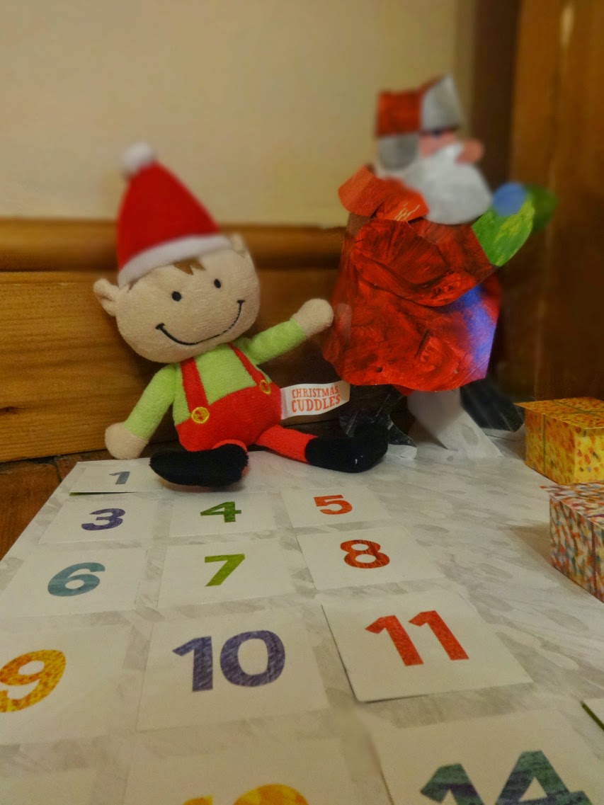 Pop Up Santa from Eric Carle's Advent Calendar and our elf