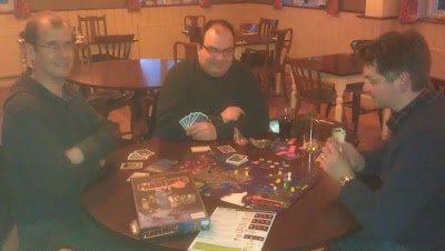 Pandemic - A very poor photo of the guys playing Pandemic. Sorry!