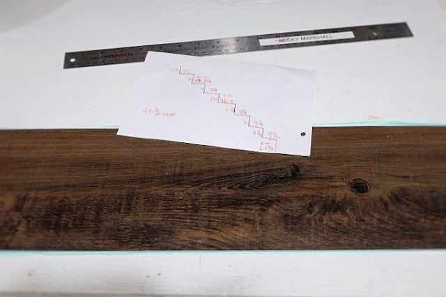 measuring and figuring out where to cut vinyl plank tile