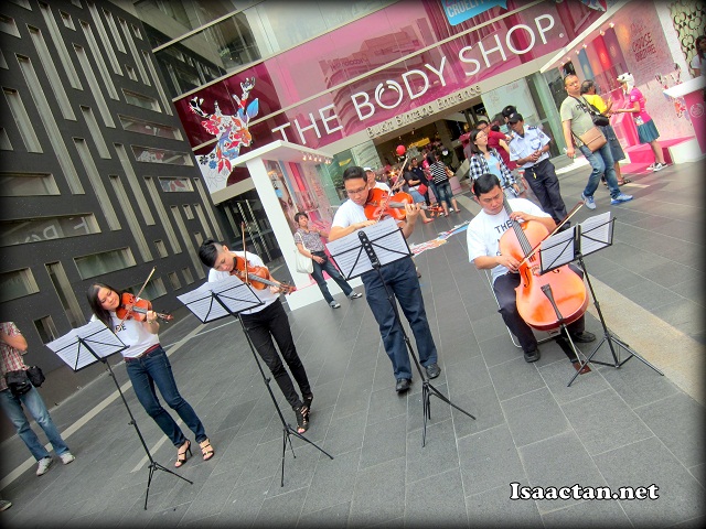 Playing a mini orchestra in the middle of the busy shopping mall, Pavilion KL