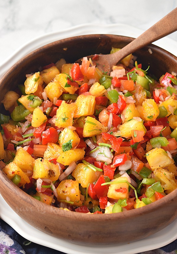 best and easy pineapple jalapeno salsa with spices,cilantro lime juice served in a bowl