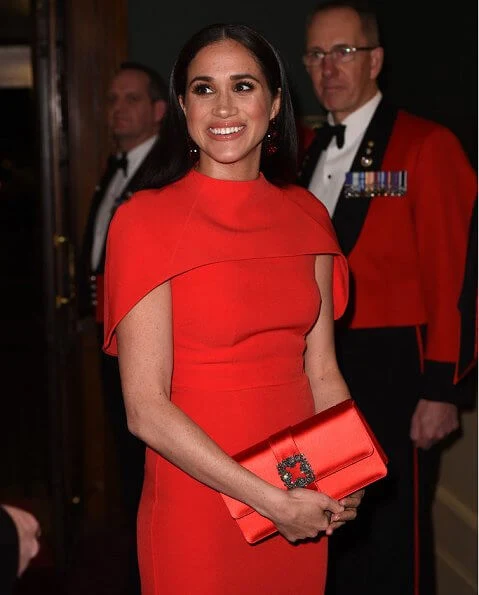 Meghan Markle wore Safiyaa Kalika dress, Stuart Weitzman Nouveau pumps, Simone Rocha earrings, Manolo Blahnik clutch bag