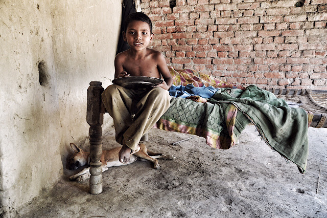 children portrait india uttar pradesh village rural boy eating 