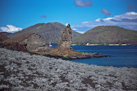 Pinnacle Rock with Shield Volcanoes in the Background