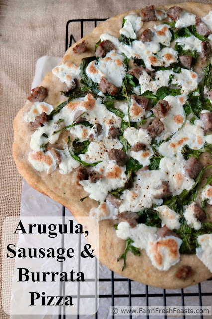 A fast and easy white pizza with fresh creamy burrata cheese, peppery arugula, and Italian sausage.