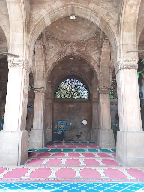 Internal archways of Sidi Saiyyeh Mosque with latticed tree design on window