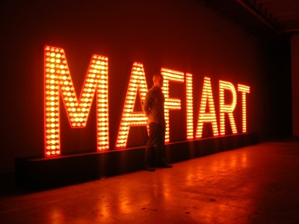 MAFIART - 2009 - Wood,metal & 852 Red & yellow flashing light bulbs 24' X 24" X 6'4"(L X W X H) or 12 m x 2,20 m Mafiart is a word creates by Klaus Guingand in 1993. Mafiart TM © Klaus Guingand