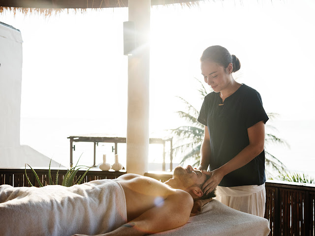 masseuse giving a massage in an open-air spa
