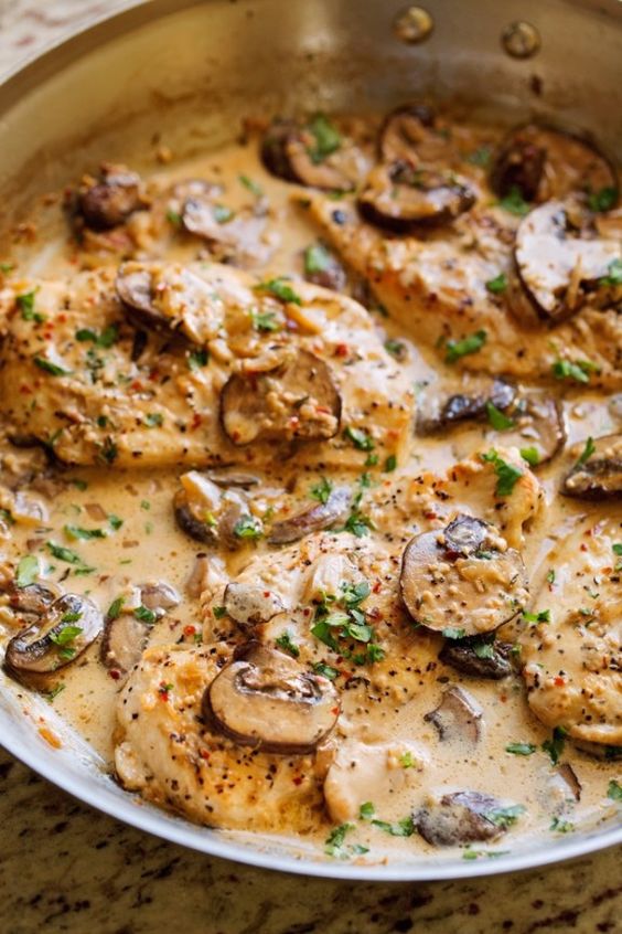 Another one skillet chicken recipe! This easy chicken dinner is made with sautéed garlic and mushrooms and topped with a creamy sauce.
