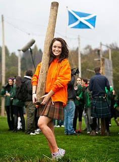 girl tossing caber