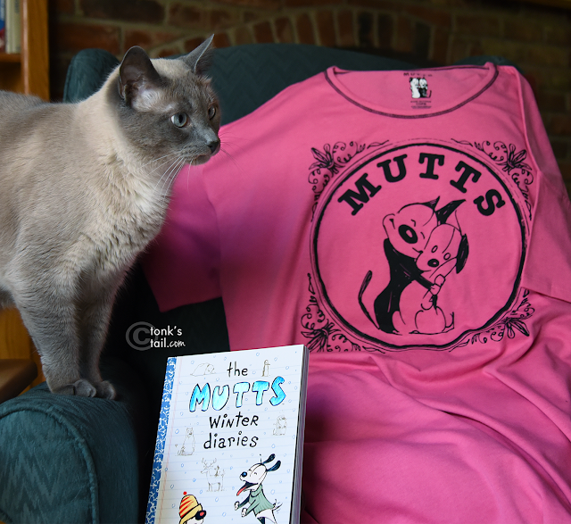 Maxwell poses with his copy of The Mutts Winter Diaries book + sleep shirt (uh, the shirt looks a bit BIG for you, dood)