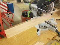 table leg being cut by a chop saw