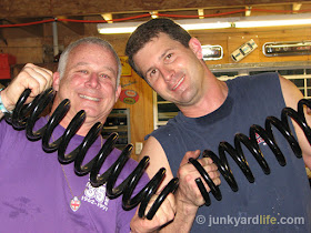 Holding the 1955 Chevy replacement heavy duty coil springs.